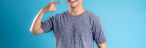 Asian young man posing on blue background