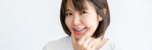 Asian woman with braces smiling happily